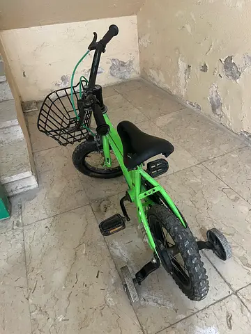 Green Children's Bicycle with Training Wheels and Front Basket