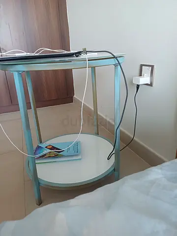 Round glass-top beautifulside table with lower shelf
