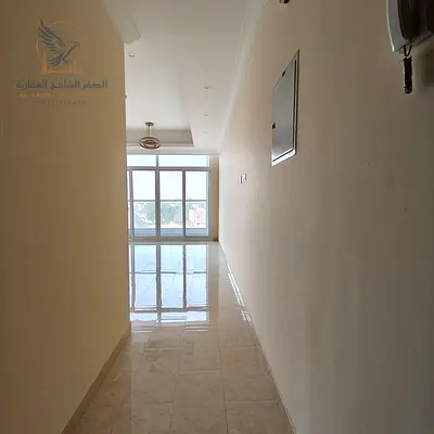 Annual apartment in Al Rawda, two bedrooms and living room, opposite Kanz Market, prime location near services, flexible payment options.