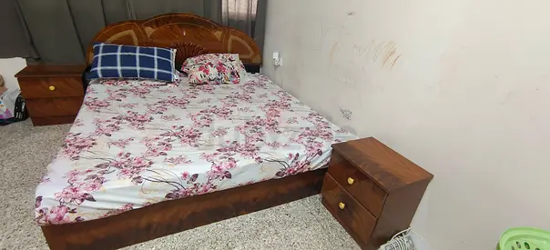 Wooden king size bed with mattress and 2 bedside drawers and tall padded head board base and storage