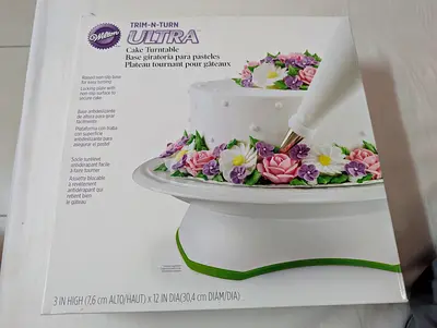 Wilton Trim 'n Turn ULTRA Cake Turntable, a 12-inch diameter rotating stand designed for cake decora