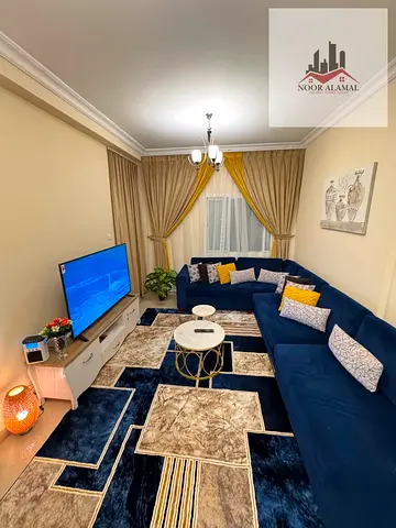 Sharjah, Al Taawun area, two-bedroom apartment with living room, two bathrooms, and balcony.