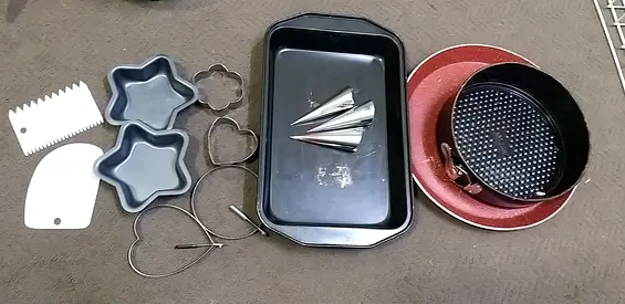 Assorted baking pans, cake tins, cookie cutters and baking tools - used set