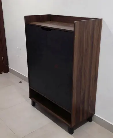 Compact wooden shoe cabinet with black doors — good condition