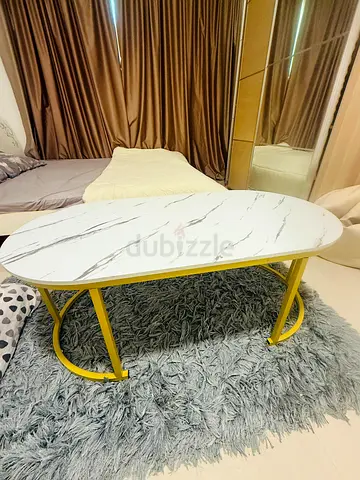 Marble-effect oval coffee table with yellow metal frame