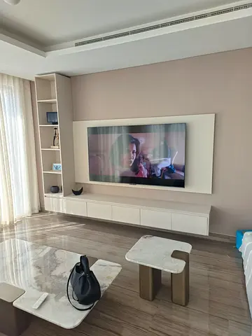 Modern wall-mounted TV entertainment unit with shelving and cabinets