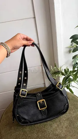 Black leather shoulder bag with brass buckles