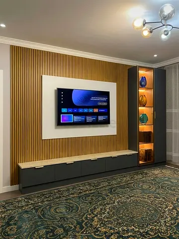 Modern wall-mounted entertainment unit with illuminated display cabinet