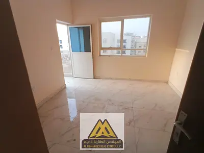 2BR apartment in Al Alia, Ajman, balcony, 2 baths, central AC, free maintenance, near services, AED