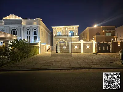 Luxury residential/commercial villa for sale in Al Muwaihat 1, with an outdoor majlis and 20-meter front parking space. The price includes electricity