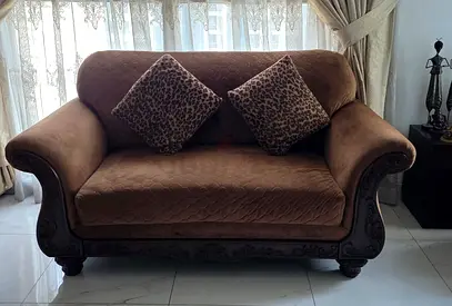 Two Brown 2-Seater Upholstered Sofa with Carved Wood Base — Fair Condition