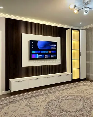 Modern wall-mounted entertainment unit with illuminated display cabinet