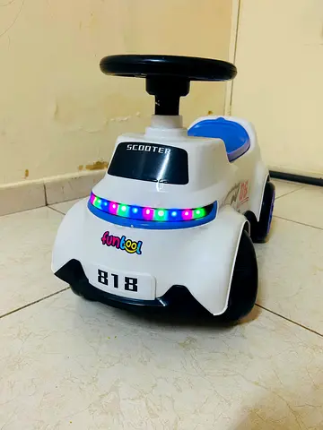 White toddler ride-on scooter with lights - excellent condition. Brand new