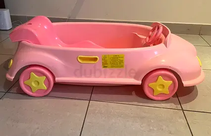 Pink bath tub with detachable reclined seat and drain plug. Barely used