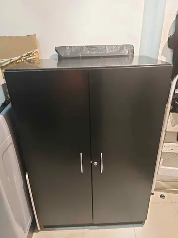 Black wooden cupboard with shelves