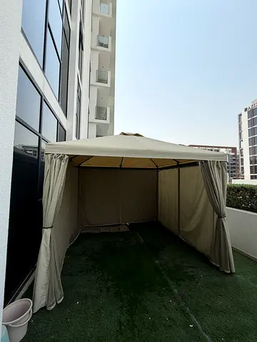 Beige outdoor gazebo/canopy tent with curtains