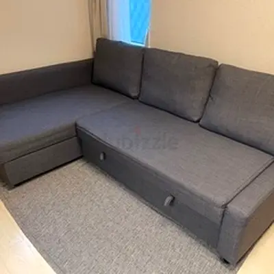 Grey L-shaped sofa bed with storage — good condition
