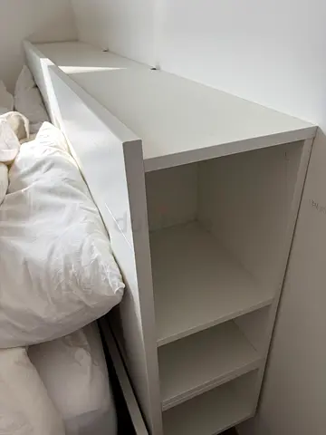 White IKEA BRIMNES bed with shelving unit. Only used as a guest bed.