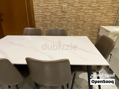 6-seater dining table with marble-effect top and chairs
