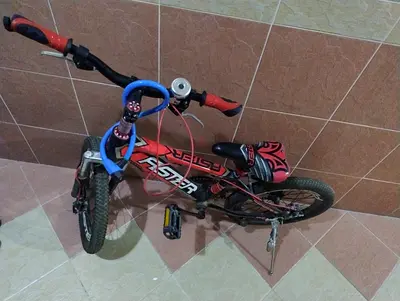 Red kids bicycle with training wheels and bell - good condition