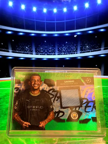 Topps Savinho Manchester City green relic card featuring a large jersey patch and numbered 03/99