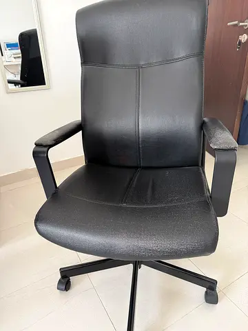 Black leather office chair with armrests and wheels