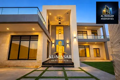 Two-story villa with a roof terrace in Al Muwaihat, featuring 7 master bedrooms and an internal elevator; includes electricity, water, and air conditi