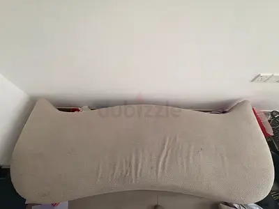 Beige curved sofa back cushion — good used condition