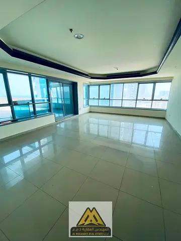 A spacious 2-bedroom apartment with a large living room is available for sale in Corniche Tower, Ajman