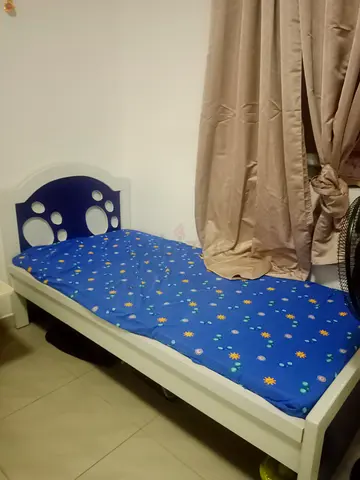 Single white wooden kids bed with mattress