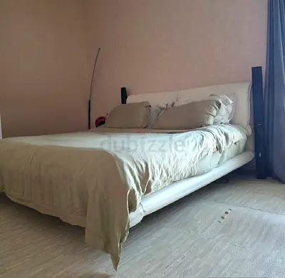Bridge king bed frame with headboard with mattress.