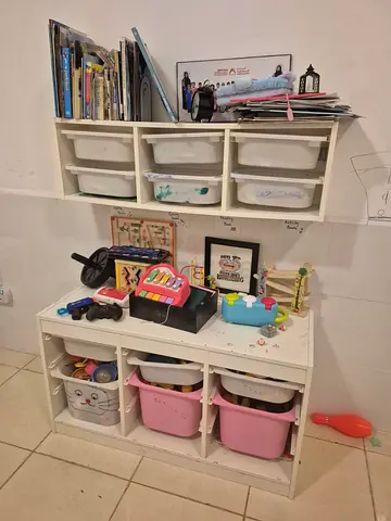 Kids toy storage unit with assorted toys and bins