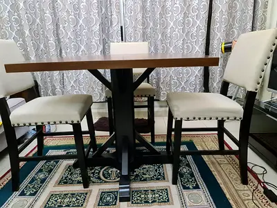 Wooden dining table with 4 upholstered chairs - solid base, good condition. Attractive Offer!!!