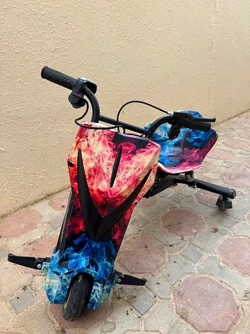 Electric Drift Trike Scooter with Flame Graphics - Good Condition.
