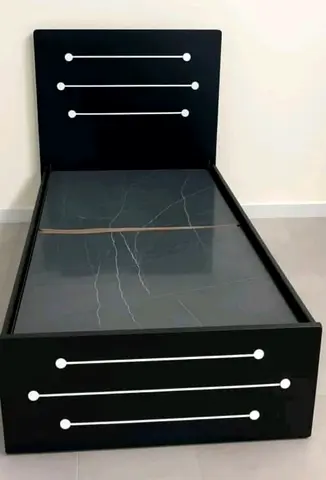 Single black wooden bed frame with headboard and decorative inlay