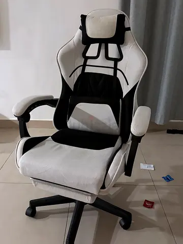 Gaming/office chair with a headrest, lumbar support, and a full footrest.