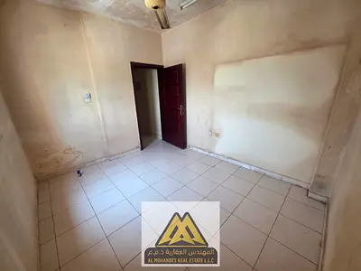 One bedroom and living room, no air conditioning. Building with elevator. Prime location on Al Rashidiya 3 Road, Ajman, next to Grand Mall, on a main