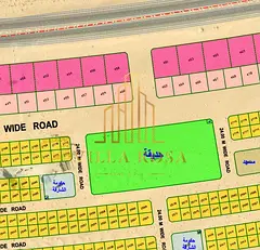 Plot of land for sale on the main Khorfakkan Road, Al Sahmah 2 area.