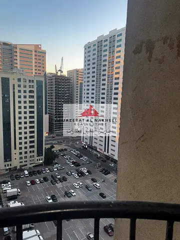 For living or investment: a two-bedroom apartment with a living room in Al Nahda, with parking, in a prime location in one of the best towers in Al Na
