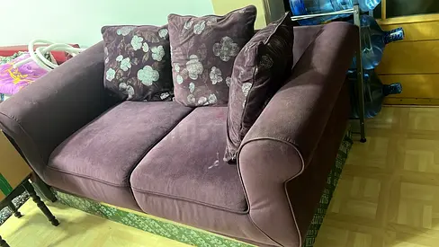 Two-seater purple fabric sofa in good used condition