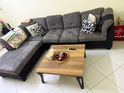 L-shaped grey fabric sofa with matching coffee table - good condition