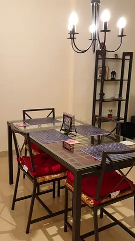 Glass dining table with 4 metal-frame chairs - good condition