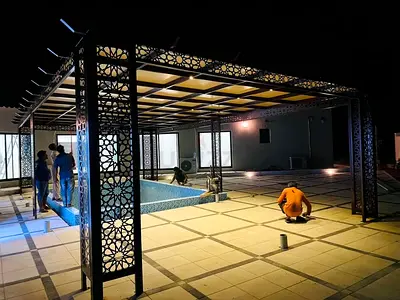 Decorative metal pergola with patterned panels — used, sturdy outdoor structure
