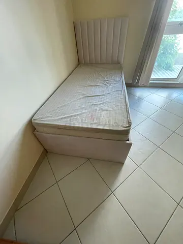 Single bed with mattress and bedsheet