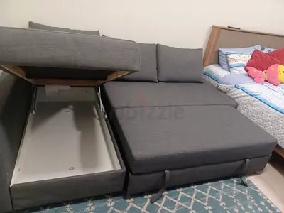 Grey L-shaped sofa bed with storage - good condition