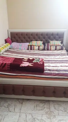 Queen size upholstered bed frame with tufted headboard and storage base