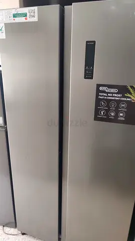 Tall side by side stainless steel refrigerator / freezer - good condition