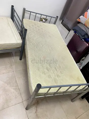 Two metal beds with their mattress.