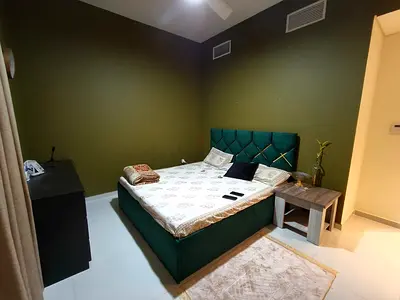 VERY GOOD CONDITION Green upholstered king size bed with headboard and with 1 king size mattress