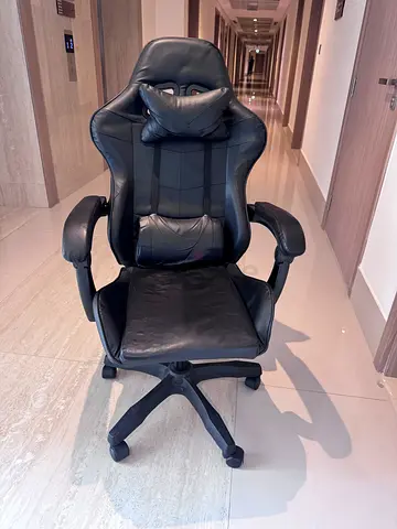Black ergonomic reclining office/gaming chair with footrest